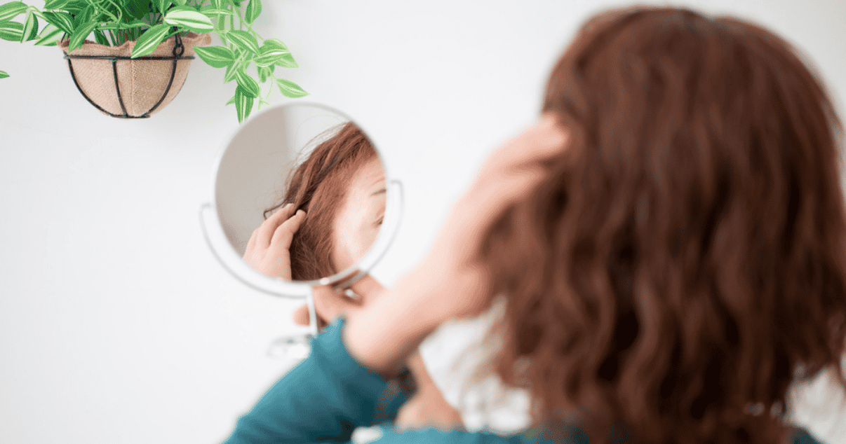 Woman looking at lace tape in hair system